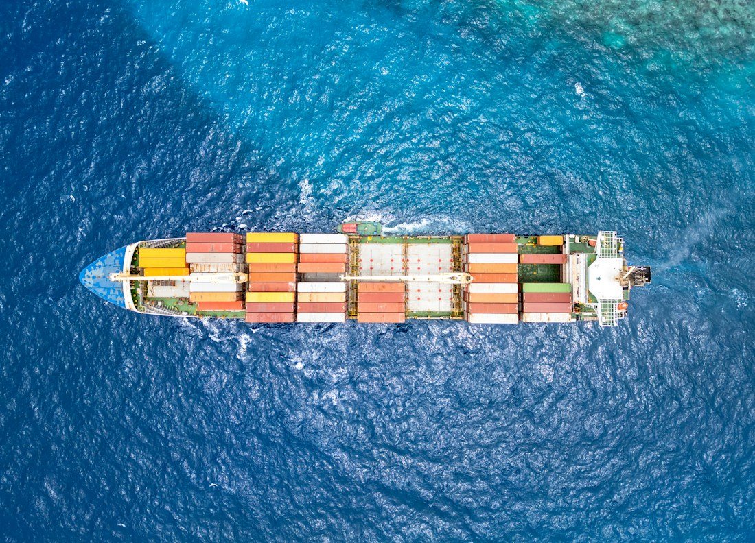 Aerial view of a cargo ship crossing open ocean